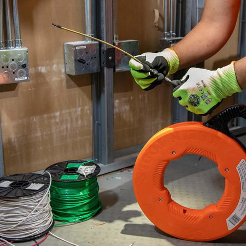 Top Shelf 13 Inch Flexible Fish Tape Leader for 1/8 Inch Steel Tapes in use, guiding cable through bends with durable materials.