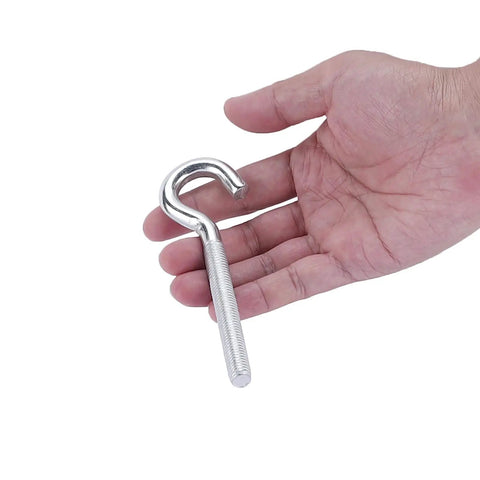 Hand holding metal hook component from Garage Door Cable And Pulley Replacement Kit With Two Pairs Of Galvanized Aircraft Cables And Four Heavy Duty Three Inch Pulleys And Fasteners For Torsion And Extension Doors Up To 12 And 9 Feet DIY Ready.
