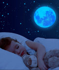 Child sleeping under Night Sky Glow Stars Ceiling Stickers Kit With 1049 Pieces Including Moon And Stars, Self Adhesive Wall Decals