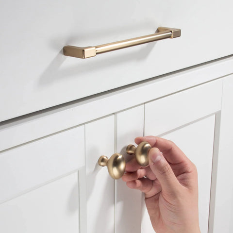 10 Pack Classic Solid Cabinet Handles Set 6.3 Inch Screw Spacing in Champagne Bronze installed on white cabinet