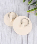 Close-up of two Rubber Sink Stoppers 4pcs with Hanging Ring for Bathtub Drains on a wooden surface.