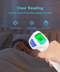 Infrared Thermometer 3 In 1 For Home Use, Nursery And Family Checks Body, Room, And Object Temps, Switch Between Fahrenheit And Celsius, Smart Fever Indicator With 3 Color Backlight, Perfect For Baby, Kids And Adults. Silent non-contact infrared thermometer showing green LCD reading over sleeping child