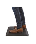 Person standing on Anti Fatigue Standing Mat 20 By 30 Inches For Home And Office Durable Self Skinning Polyurethane Reduces Fatigue