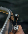 Using 22 Piece Double Sided Bit Kit Workhorse with Flat End Ratchet Driver for multitools on metal surface, close-up view.