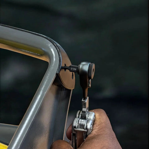 Using 22 Piece Double Sided Bit Kit Workhorse with Flat End Ratchet Driver for multitools on metal surface, close-up view.
