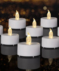 Flameless Tea Lights Battery Operated Candles Set Of 24 LED Flickering Votive Candles with warm white glow on reflective surface
