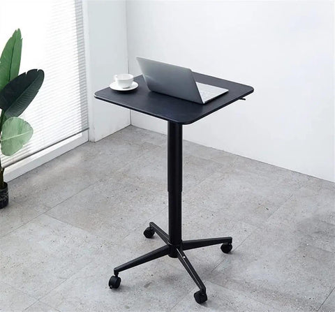Heavy Duty Steel Height Adjustable Standing Desk Featuring No Fuss Manual Crank And Sturdy Casters Perfect For Your Home Office Grind Or Gaming Zone With Smooth Moving Ergonomic Design Built Tough, black top with laptop and coffee.