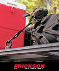 Pro Series 1 Inch By 10 Foot Black Retractable Ratchet Tie Down Straps Set Of 2 securing a red cooler and tire on a truck bed