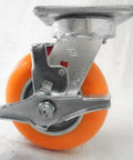 Heavy Duty Kingpinless Swivel Casters Set Of Four With Solid Foot Brakes 6 Inch Orange Polyurethane Wheels side view showing brake mechanism.