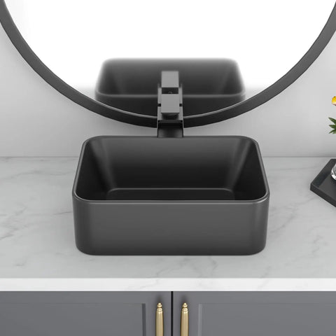 Square black vessel sink on modern vanity countertop with round mirror, not the Egg Shape Above Counter Vessel Sink In White Ceramic Porcelain 16 By 13 Inch Oval Vanity Lavatory Basin For Modern Bathrooms With Slick Easy To Clean Finish Not Included Faucet And Drain.
