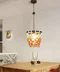 Basketball Hoop Pendant Light With Net and Acrylic Shade hanging over dining table, vintage style for kids' room, gym, or loft.