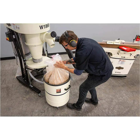Man using Portable 2 HP Cyclone Dust Collector With 7 Inch Inlet, 20 Gallon Drum, 1023 CFM Airflow, 3450 RPM, Welded Steel Impeller