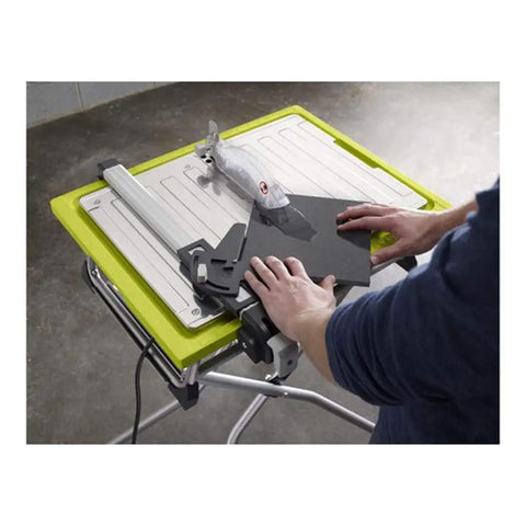 User operating the Badass 7 Inch Portable Wet Tile Saw With Tough Stainless Steel Table for precise ceramic cutting.