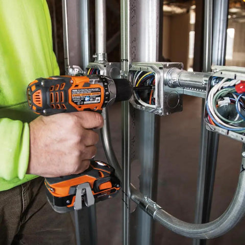 Person using drill from 26-Piece Impact Driver Bit Set With Nut Driver And Screwdriver Bits In Durable Case on electrical box