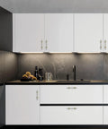 Stylish kitchen with 10 Pack 3 Inch Cabinet Handles in Brushed Nickel and Gold Finish on white cabinets, enhancing modern decor.
