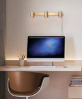 Three Light Plug-In Track Lighting In Matte Brass With Adjustable Heads, 15-Foot Cord, mounted on wall above desk
