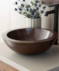 Premium Slick Vessel Bathroom Sink Made From Tough 16 Gauge Hammered Copper With An Antique Bronze Finish view on countertop.