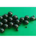 Twenty Piece Lot Of 1.588Mm Silicon Nitride Ceramic Balls G5 Grade on green background, showing precision ceramic balls for bike hubs.