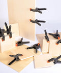 Twenty 3.5-inch plastic spring clamps, black with orange tips, for crafts, woodworking and photography