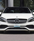 Front view of a white car with "Two Pack Stainless Steel License Plate Frame Set With Screw Caps And Screwdriver Set For 2 Hole Plates Durable Adventure Themed Cover That Will Not Fade Weatherproof And Easy To Install For Women And Everyday Riders".