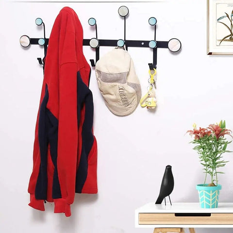 Round Dot Wrought Iron Wall Hook Absolute Game Changer For Entryway Storage, holding a red jacket and hat, displayed on a wall.