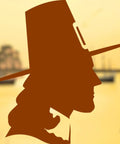 Silhouette of a historical figure with hat in front of a blurred ship, embodying sea adventures and freedom.