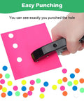 Person using Heavy Duty Three Eighths Inch Single Hole Punch For Paper Crafts Portable Ten mm Circle Hole Puncher on pink paper with colorful stickers.
