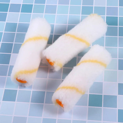 Three slick high density foam covers from the Twenty Piece Mini Paint Roller Kit featuring yellow stripes for precise wall jobs.