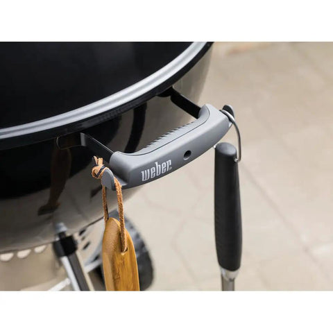 Close-up of handle and hook on Original Kettle Premium Charcoal Grill 22 Inch Black Outdoor BBQ Grill With Built In Thermometer
