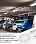 Four Pack 6 Foot T5 T8 LED Shop Light Connecting Wires Dual Ended Linkable Cables For LED Tube Fixtures No Soldering Required Plug And Play 3 Pin Connectors For Ceiling Lamps in a parking garage setting.