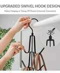 Hand holding upgraded swivel hook design for 2 Pack Closet Purse Hangers with rotating functions, black metal