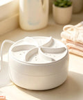 Real Deal Mini Portable Clothes Washer Featuring Ultrasonic Turbo Wash Technology on countertop with socks.