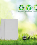 White Paper Gift Bags With Handles Bulk 25 Pcs 8x4.5x10 Medium Size shown with eco-friendly icons on grass background