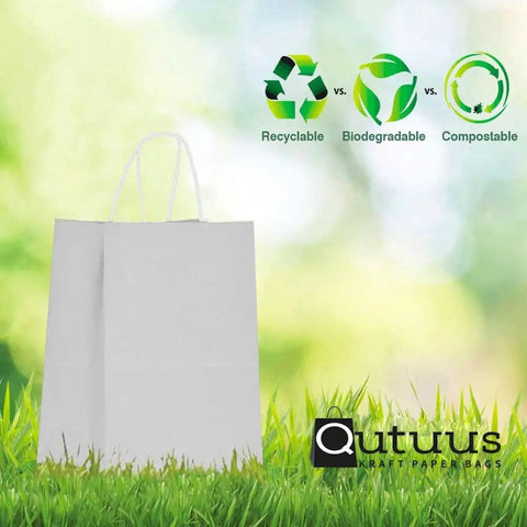 White Paper Gift Bags With Handles Bulk 25 Pcs 8x4.5x10 Medium Size shown with eco-friendly icons on grass background