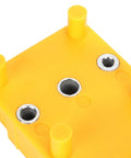 Rock Solid Doweling Jig Kit 38 Piece Self Centering Woodworking Drill Guide top view of yellow base and holes for precise drilling.