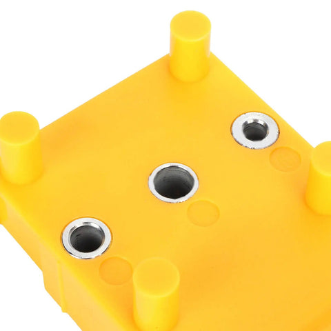 Rock Solid Doweling Jig Kit 38 Piece Self Centering Woodworking Drill Guide top view of yellow base and holes for precise drilling.