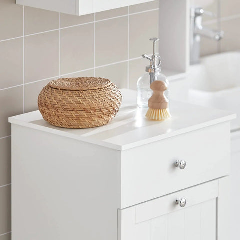 White Slim Tilt-Out Laundry Hamper Cabinet For Tight Spaces with decorative items on top