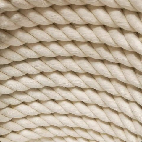 Close-up of One Half Inch Natural Twisted Cotton Rope thick and soft dope for macrame, decor, crafts, camping, and DIY projects. Beige color.