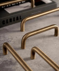 Close-up of U Shaped Antique Brass Brushed Furniture Handle With Solid Shell Drawer Knob for cabinets, 320mm pitch