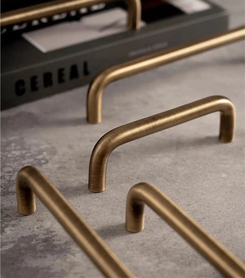 Close-up of U Shaped Antique Brass Brushed Furniture Handle With Solid Shell Drawer Knob for cabinets, 320mm pitch