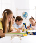 Children engaging with DIY Electric Conveyor Belt Kit For Kids Hands On STEM Learning, 2 Piece Educational Model in classroom setting.
