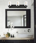Three Light Matte Black Vanity Light With Seeded Glass Shades Above Bathroom Mirror