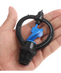 Hand holding 360 Degree Garden Sprinkler Nozzle For Lawn And Garden 1/2 Inch To 3/4 Inch Rotary Irrigation Sprayer with blue nozzle tubes