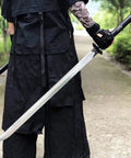 Person holding Hand Forged Longquan Style Dao Sword With High Carbon Steel Blade Full Tang And Dope Matte Black Wooden Scabbard