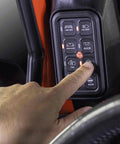 Hand operating Jeep Wrangler JK 2007 2018 8 Gang A Pillar Switch Panel System for 12V Accessories in vehicle interior.