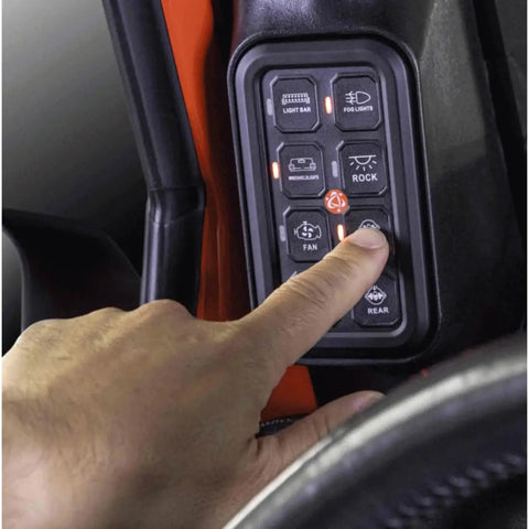 Hand operating Jeep Wrangler JK 2007 2018 8 Gang A Pillar Switch Panel System for 12V Accessories in vehicle interior.