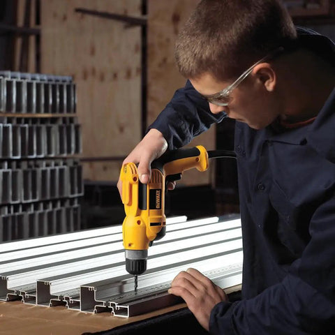 Person using Corded Drill Beast With 8 Amp Motor, 0-2,500 RPM, 3/8 Inch Keyless Chuck, Pistol Grip, in workshop on metal tracks.