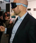 Man wearing Fatigue Goggles Realistic Sleepiness Simulator For Drowsy And Distracted Driving Training in an indoor setting.