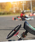Close-up of Deep Dish 14 Inch PU Racing Steering Wheel with red horn button on kart at outdoor track.