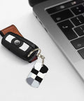 Heavy Duty Aluminum Keychain With Black And White Piano Plate Grid Print Rectangular Steel Keyring Built Tight For Everyday Carry Clean Aesthetic Daily Driver Gift Ready attached to a car key by laptop